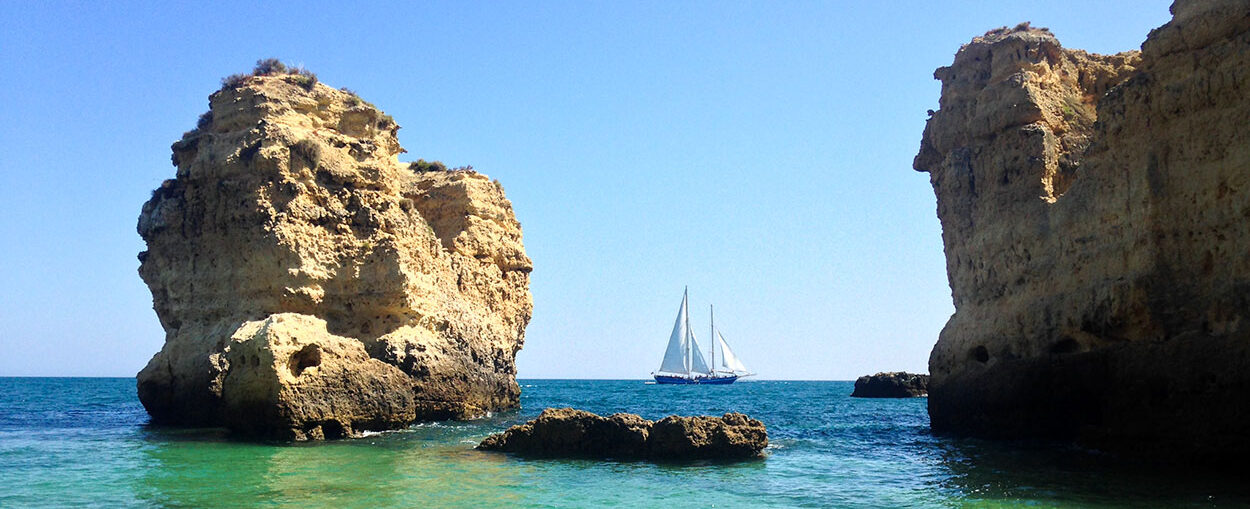 Sandra CH Smith's sailboat moving through narrow Pacific rocks